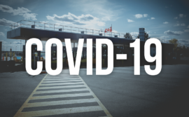 Image of border crossing with the words "COVID-19"