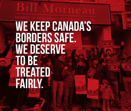 Picture of demo in front of Morneau's office in Toronto stating "We keep Canada's borders safe. We deserve to be treated fairly"