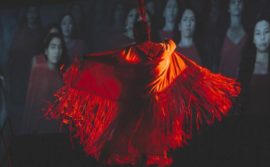image of an Indigenous dancer wearing a red dress