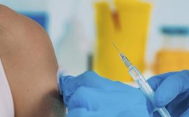 Image of arm about the receive a vaccine